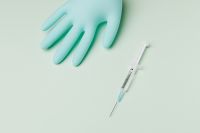 Kaboompics - Single Syringe Beside Blue Nitrile Gloves on Mint Surface