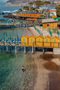 Kaboompics - Swimmer Wading Beside Colorful Beach Huts In Sorrento