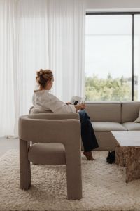 Kaboompics - Woman Reading in an Armchair by the Window