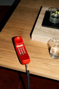 Kaboompics - Retro Red Telephone On Wooden Coffee Table Minimal Scene