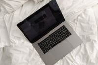 Kaboompics - Overhead Laptop on Rumpled White Bedding for Work From Bed