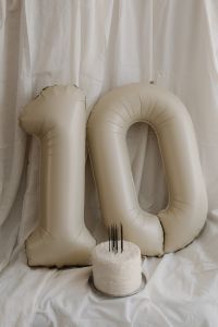 Kaboompics - White Inflatable Number Balloons with a Small Cake