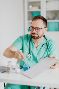Kaboompics - Doctor Holding Clipboard During Office Consultation