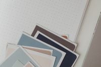 Kaboompics - Neutral Color Swatches on Dotted Notebook Near Laptop