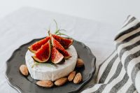 Kaboompics - Overhead Camembert with Figs and Almonds on a Dark Plate