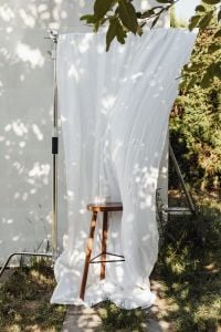 Kaboompics - White Linen Curtain Stand with Greenery and Sunlight