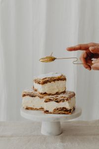 Kaboompics - Hand Holding a Perforated Sugar Sifter Above Napoleonka Cake
