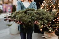 Kaboompics - The woman is holding pine branches in her hands