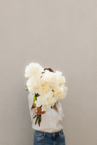 Kaboompics - Woman Holding White Flower Bouquet over Her Face
