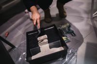 Kaboompics - Hand Loading Gray Paint onto a Roller in a Tray, Painting Tools and Studio Process