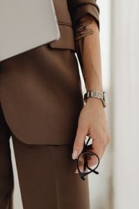 Kaboompics - Woman Holding Laptop and Glasses Near Window