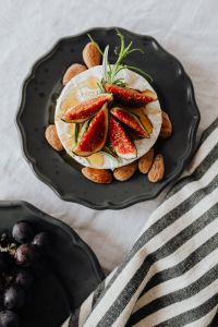 Kaboompics - Top-Down Camembert with Figs, Almonds and Rosemary on Black Plate