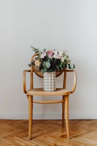Kaboompics - Pastel Flower Bouquet on Cane Chair with Copy Space