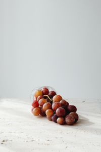 Kaboompics - Red Grapes on Pale Stone with Soft Minimal Copy Space