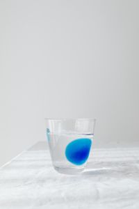Kaboompics - Close-Up Blue-Tinted Water Glass and Fabric Shadow, Abstract Beverage Background