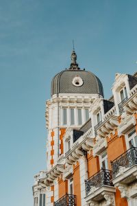 Kaboompics - Vertical Madrid View of a Tiled Dome and Sculpted Rooftop Finial