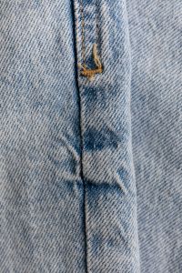 Kaboompics - Faded Light Wash Denim Seam with Reinforced Tan Topstitching, Apparel Detail