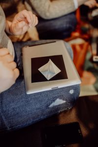 Kaboompics - Hands and Origami Paper Resting on a Woman's Lap