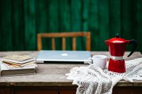 Kaboompics - Remote Work Desk With Laptop, Coffee Cup and Vintage Books