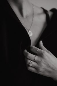 Kaboompics - Black and White Close-Up of Pendant Necklace and Ringed Hand