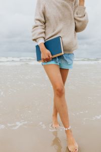 Baltic Beach Lifestyle with a Woman Reading, Books and an Orange Kayak