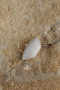 Kaboompics - Pearl-Shaped Evening Clutch on Light Coastal Stone