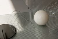 Kaboompics - Abstract Geometric Still Life with White Sphere and Wire Grid