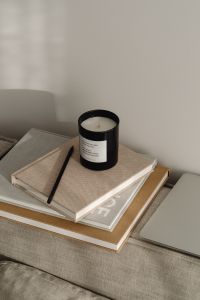 Kaboompics - Black Jar Candle, Pencil and Planner on a Neutral Sofa, Home Office Still Life