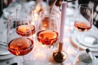 Kaboompics - Rose Wine Glasses on a Christmas Table with Warm Candlelight