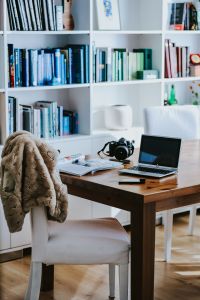 Kaboompics - Laptop and Camera on a Wooden Desk Beside a Draped Chair