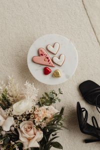 Kaboompics - Valentine Heart Cookies and Foil Chocolates on a White Plate