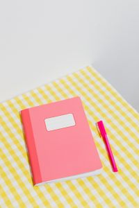 Kaboompics - Pink School Notebook and Pen on a Yellow Gingham Background