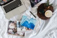 Kaboompics - Bed full of pillows and notebooks with Apple gadgets
