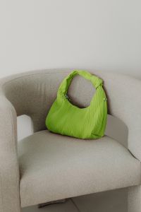 Kaboompics - Lime Green Handbag on a Neutral Armchair