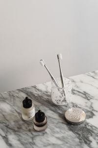 Kaboompics - Toothbrushes and Cosmetics on Arabescato Marble