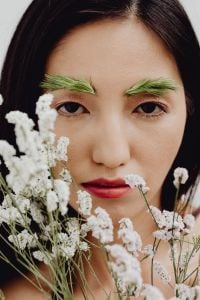 Kaboompics - Asian Woman Floral Beauty Portrait with Green Grass Eyebrow Makeup and White Flowers