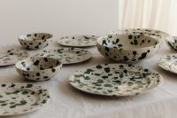 Kaboompics - Green Splatter Ceramic Tableware Spread across a Linen Table