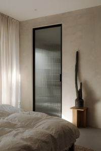 Kaboompics - Minimal Bedroom Corner with Potted Cactus and Fluted Glass Door
