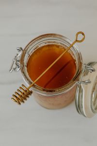 Kaboompics - Top-Down Close-Up of a Honey Jar and Dipper, Food Styling