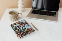 Kaboompics - Floral Notebook, Coffee and Laptop for Creative Work from Home