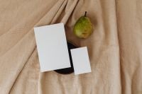 Kaboompics - Wide Business Card Mockup Pair with a Green Pear on Beige Linen