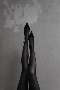 Kaboompics - Black and White Legs Raised Against a Wall in Black Heels