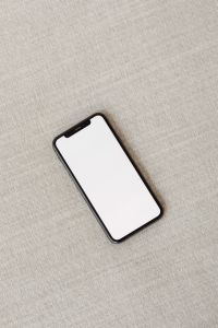 Kaboompics - Diagonal Phone Screen Mockup on a Couch with Negative Space