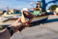 Kaboompics - Chocolate Ice Cream Cone with Boats at a Sunny Seaside Marina