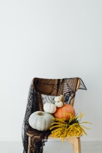 Kaboompics - Halloween Pumpkin Chair Display with Yellow Flowers