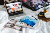 Kaboompics - Bed full of pillows and notebooks with Apple gadgets