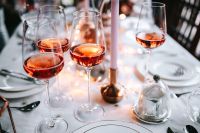 Kaboompics - Festive Rose Wine Glasses with Candlelight and Soft Background