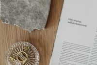 Kaboompics - Irregular Marble Slab and Open Book on a Warm Wood Table