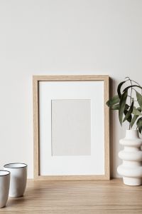 Kaboompics - Empty Frame Mockup with Greenery and Ceramic Vase for Minimal Home Decor