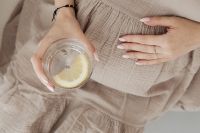 Kaboompics - Close Up of Lemon Water Over Beige Dress